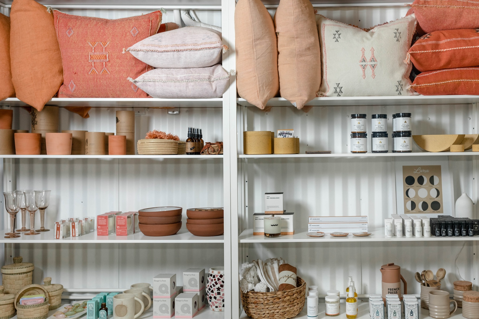 shelves with pillows, candles, and bowls