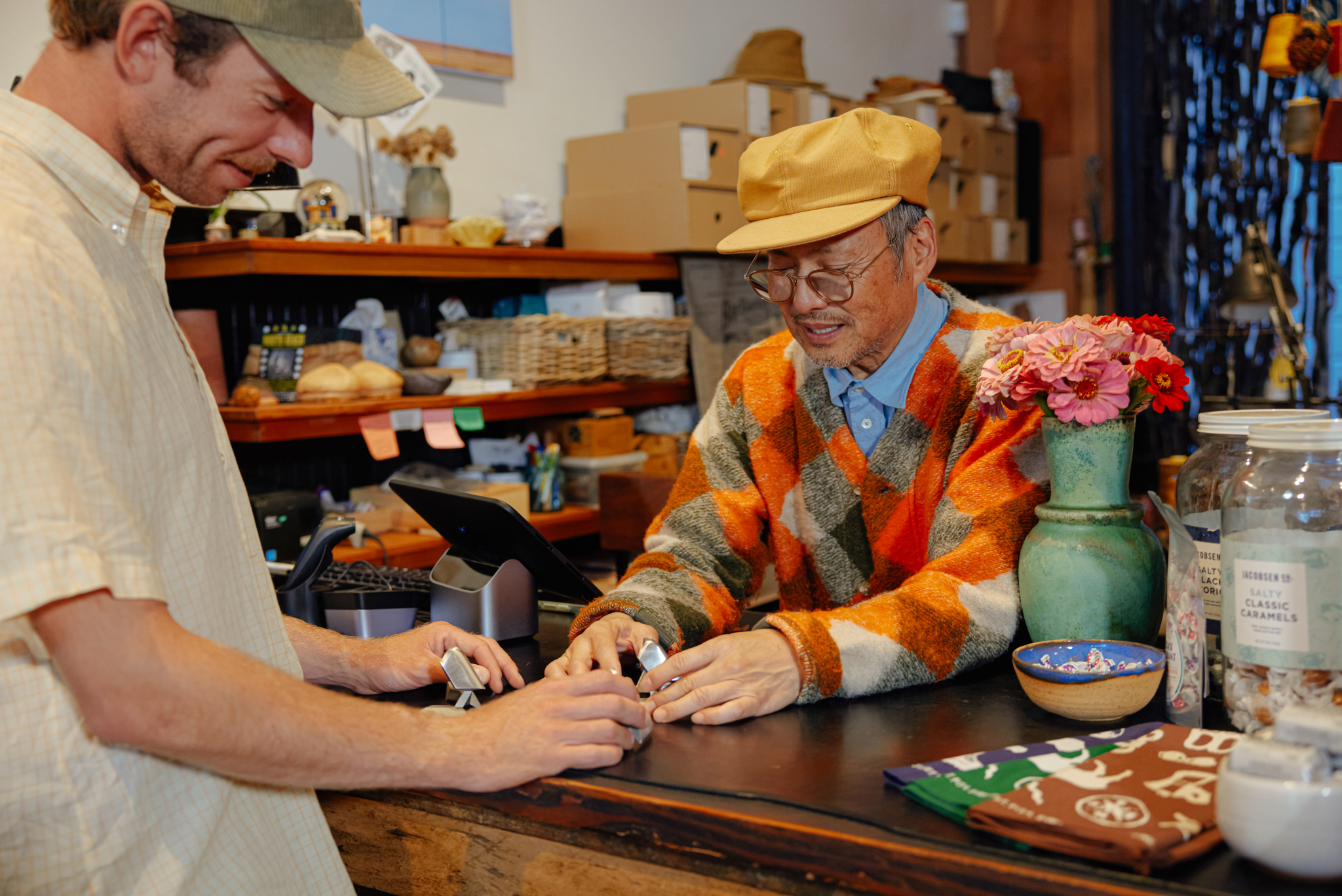 a shopkeeper checks out a customer