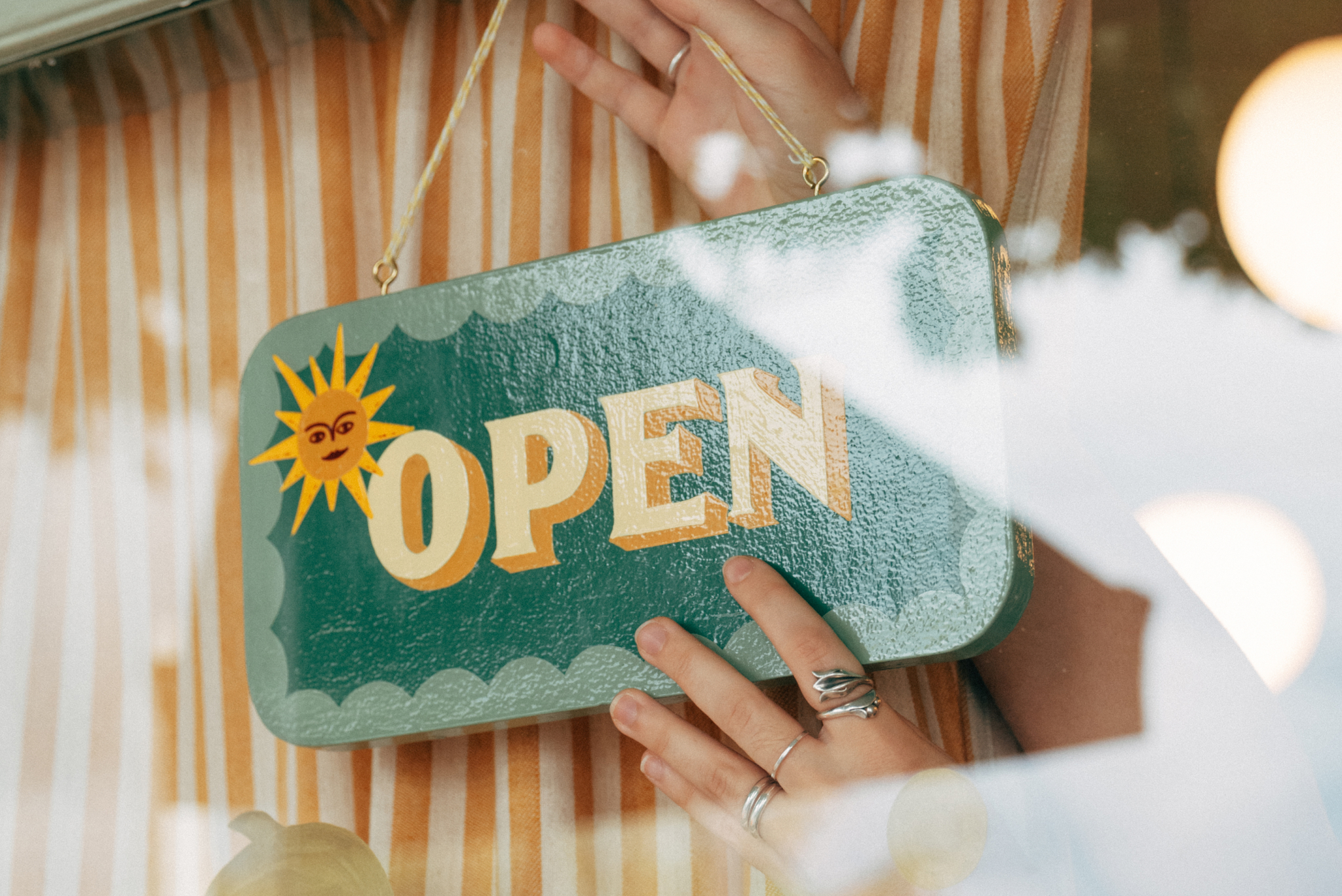 An open sign is hung in a window