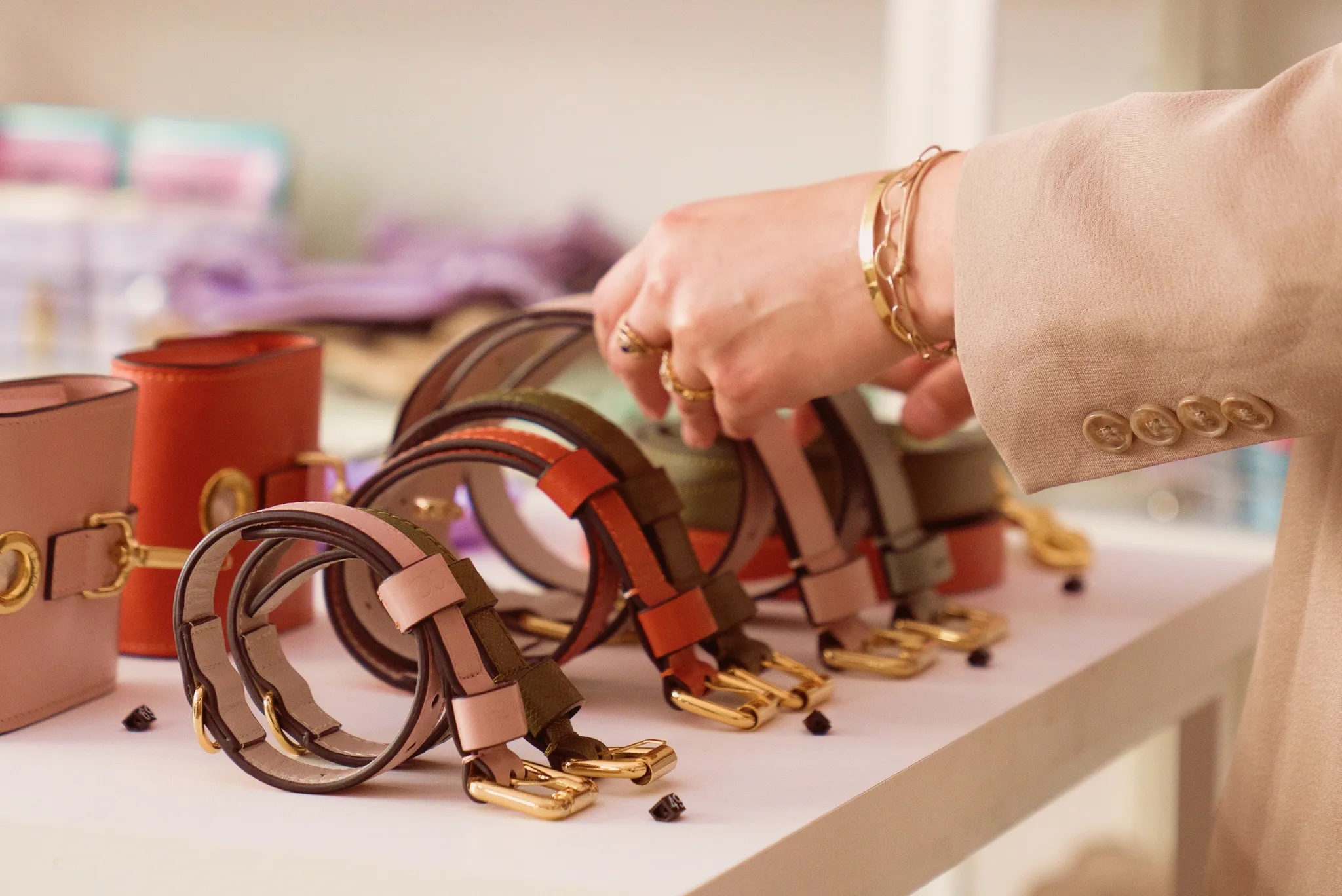 a shopper's hands pick a dog collar from a selection