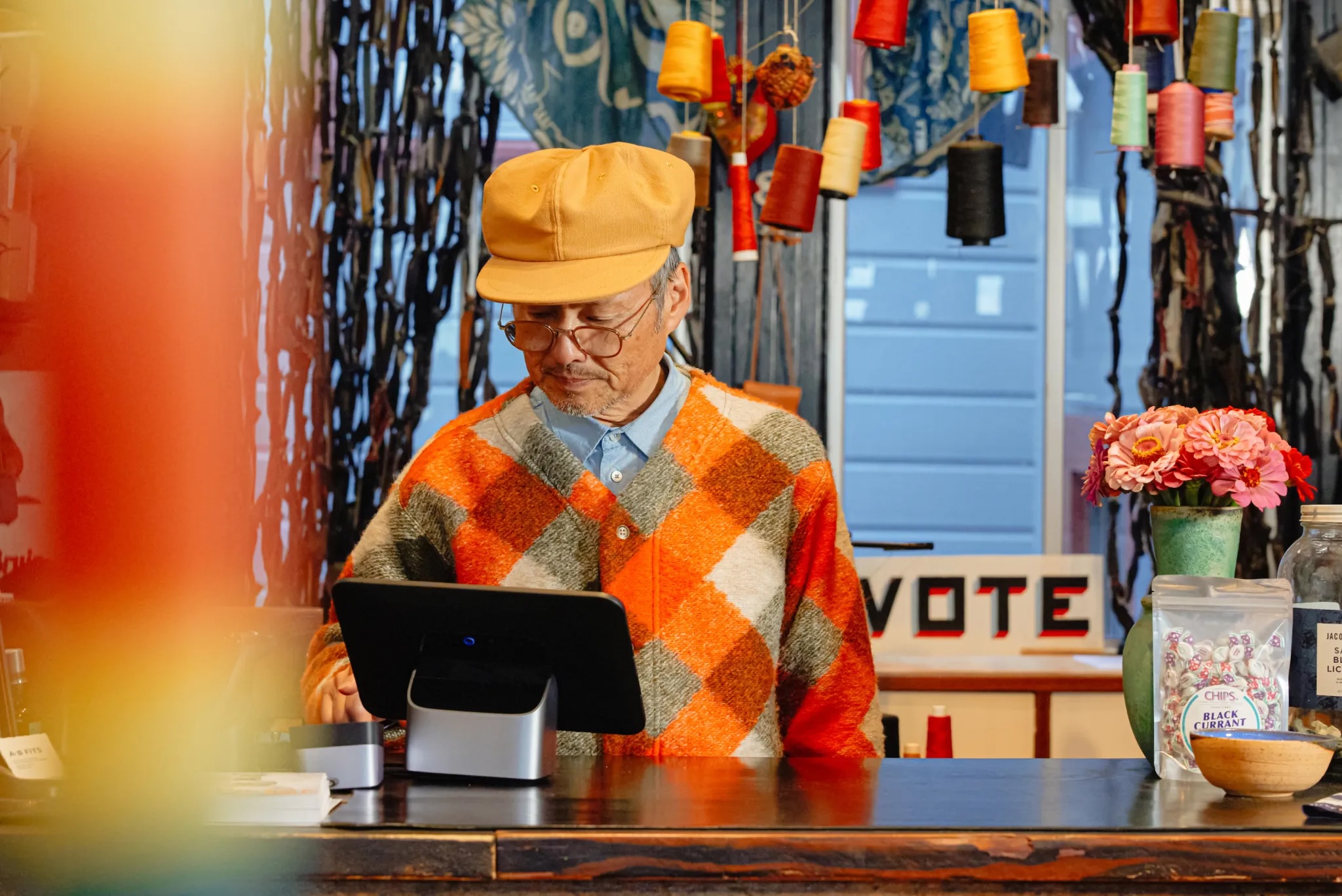 a shopkeeper uses a cash register